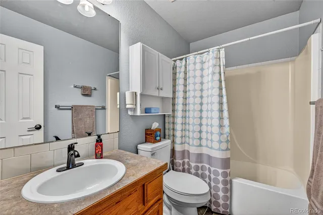 a bathroom with a sink toilet tub and shower