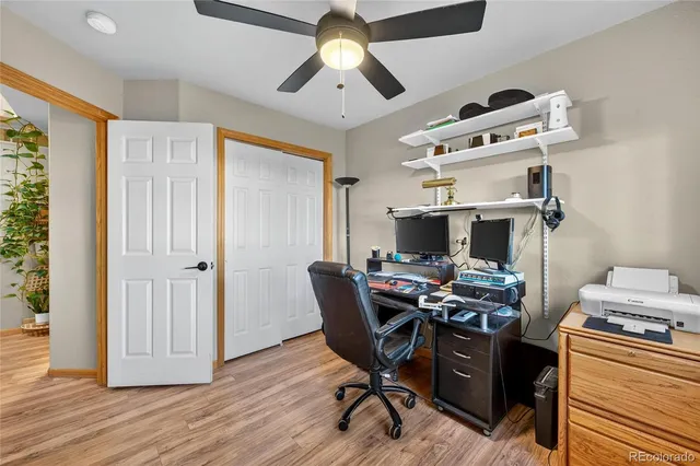 a view of a workspace with furniture and a window