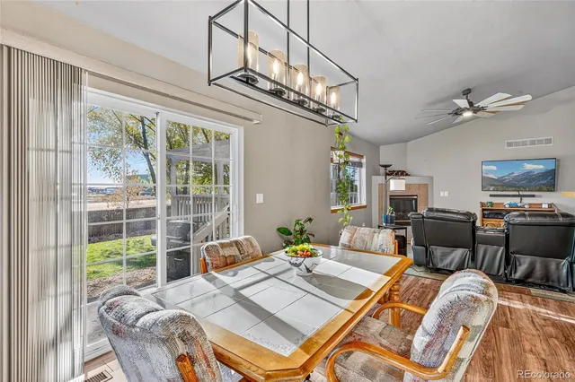 a living room with furniture a floor to ceiling windows and a flat screen tv