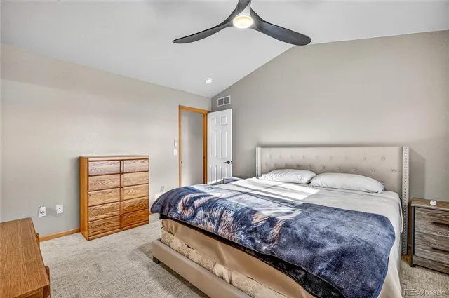 a spacious bedroom with a bed and a window