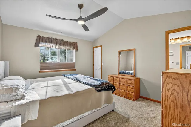 a bedroom with a bed and dresser with mirror