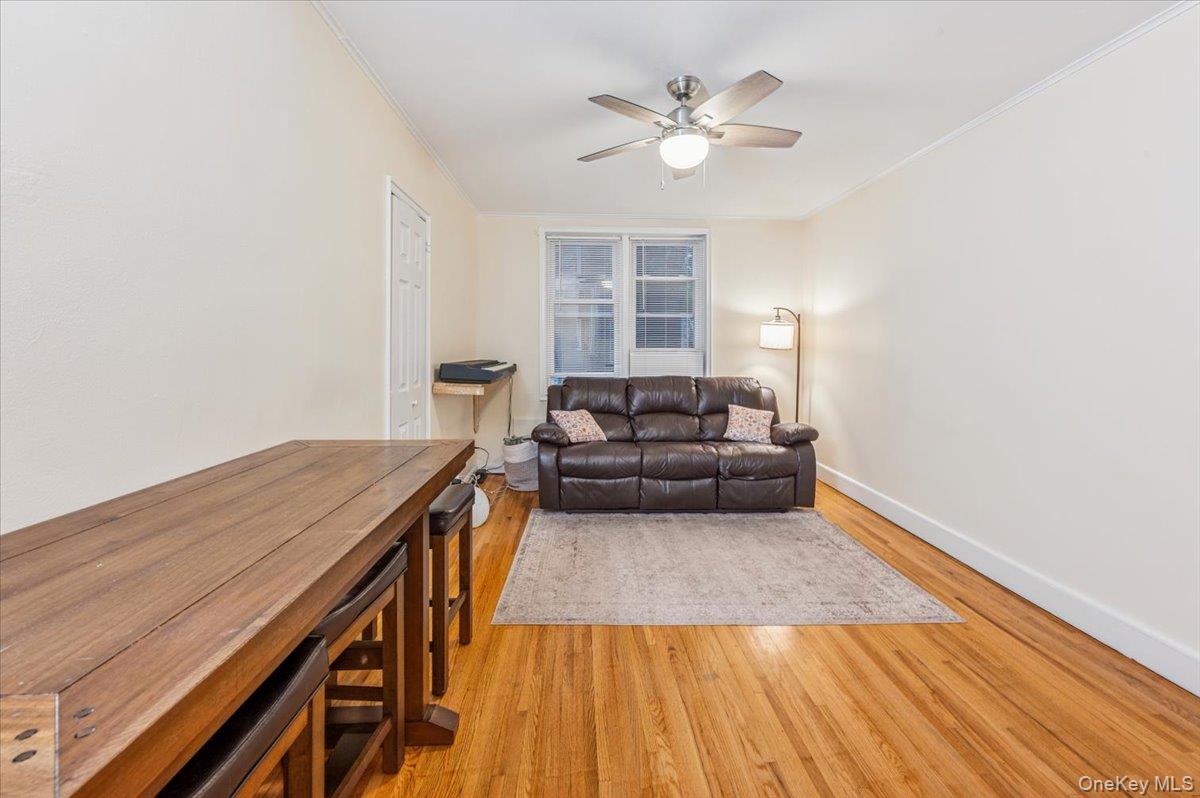 600 Pelham Road, Unit A2D New Rochelle, NY 10805 - Photo 8 of 19 Living room featuring crown molding, light wood finished floors, and ceiling fan