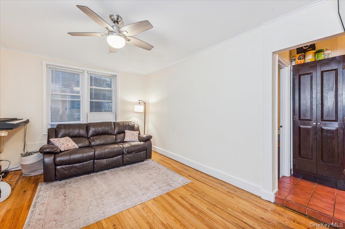 600 Pelham Road, Unit A2D New Rochelle, NY 10805 - Photo 10 of 19 Living area with light wood-type flooring, ornamental molding, and ceiling fan