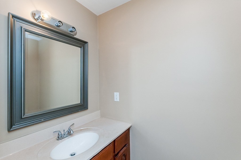 232 Pearl Street, Unit 232 Newton, MA 02458 - Photo 11 of 27 a bathroom with a sink and a mirror