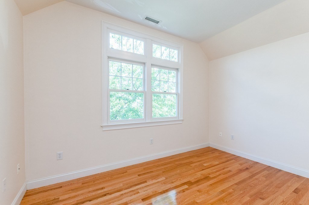232 Pearl Street, Unit 232 Newton, MA 02458 - Photo 15 of 27 an empty room with wooden floor and windows