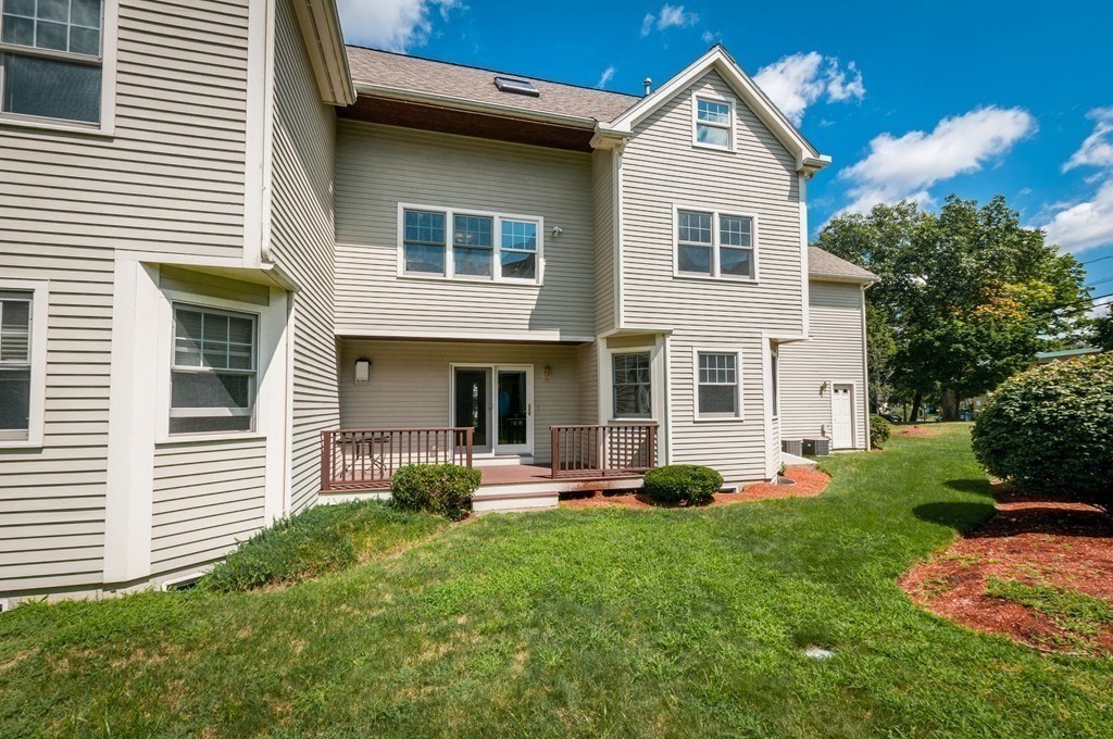 232 Pearl Street, Unit 232 Newton, MA 02458 - Photo 2 of 27 a front view of a house with garden and porch