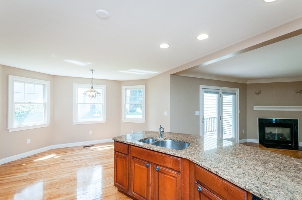 232 Pearl Street, Unit 232 Newton, MA 02458 - Photo 6 of 27 a view of a kitchen counter top space and wooden floor