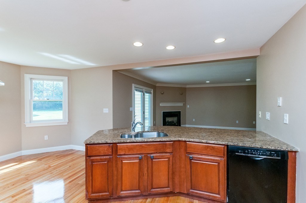 232 Pearl Street, Unit 232 Newton, MA 02458 - Photo 7 of 27 a kitchen with granite countertop a sink and cabinets