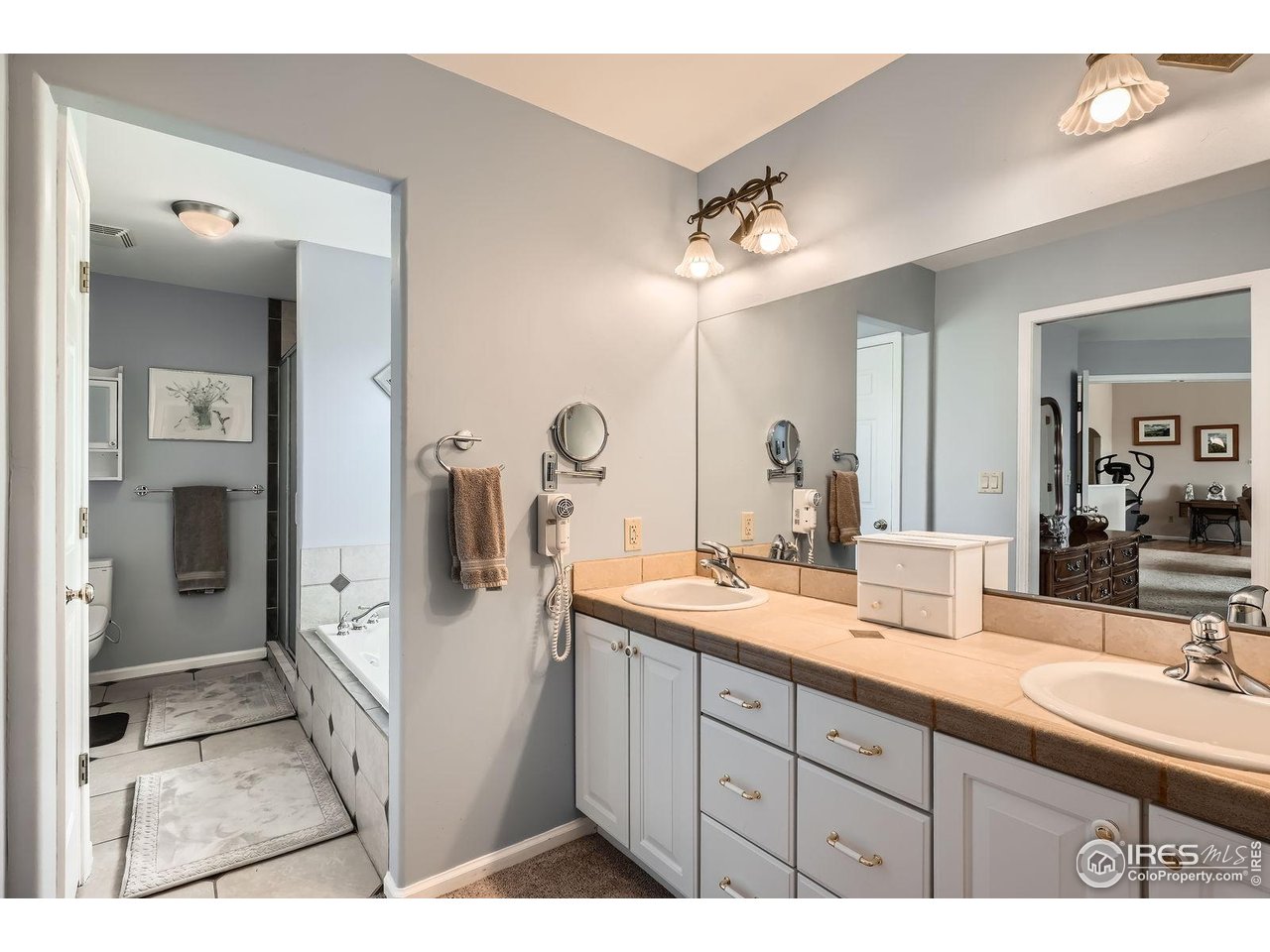 557 Highpoint Circle Black Hawk, CO 80422 - Photo 15 of 32 a bathroom with a double vanity sink mirror and shower