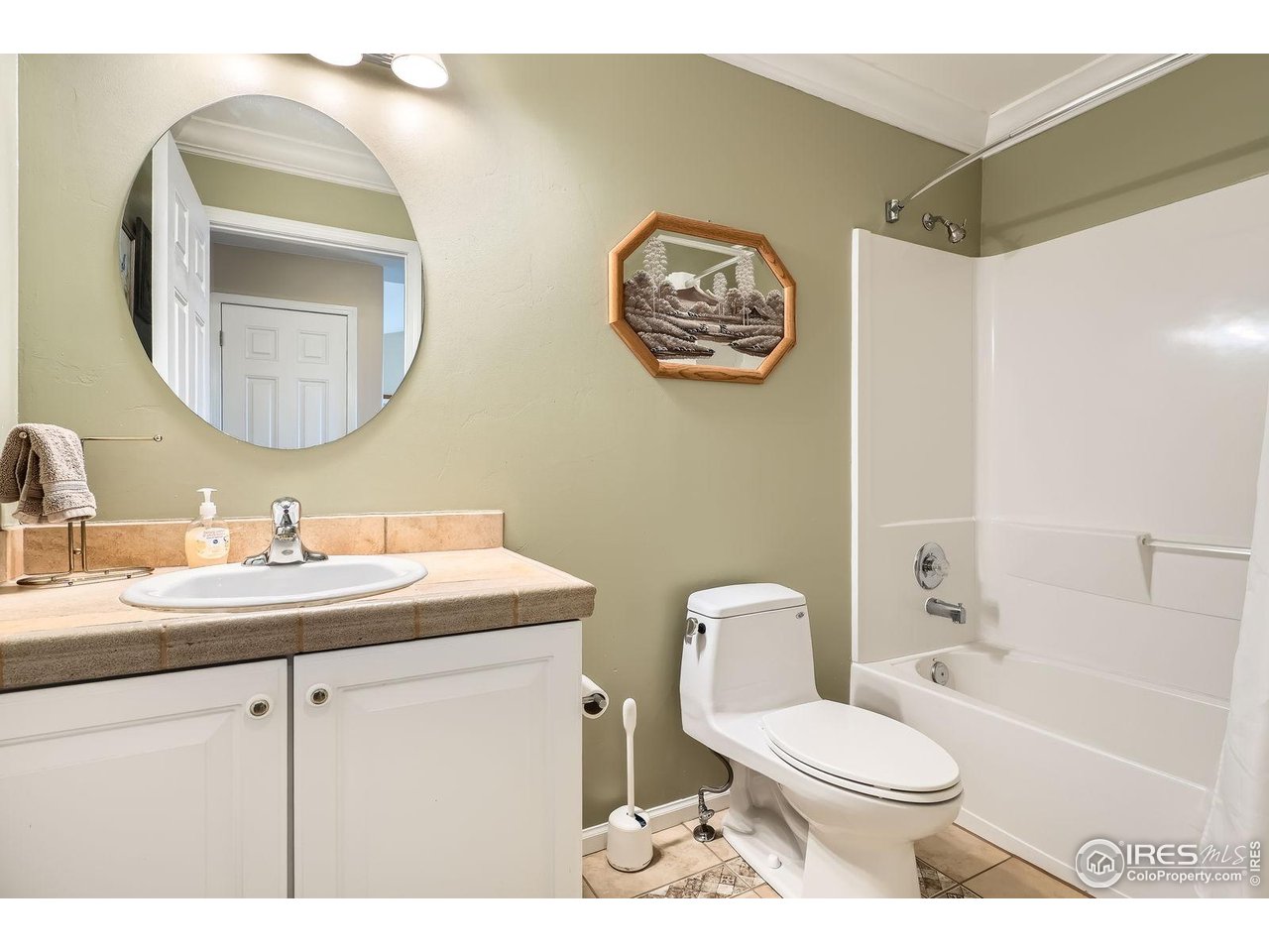 557 Highpoint Circle Black Hawk, CO 80422 - Photo 19 of 32 a bathroom with a toilet a sink and mirror