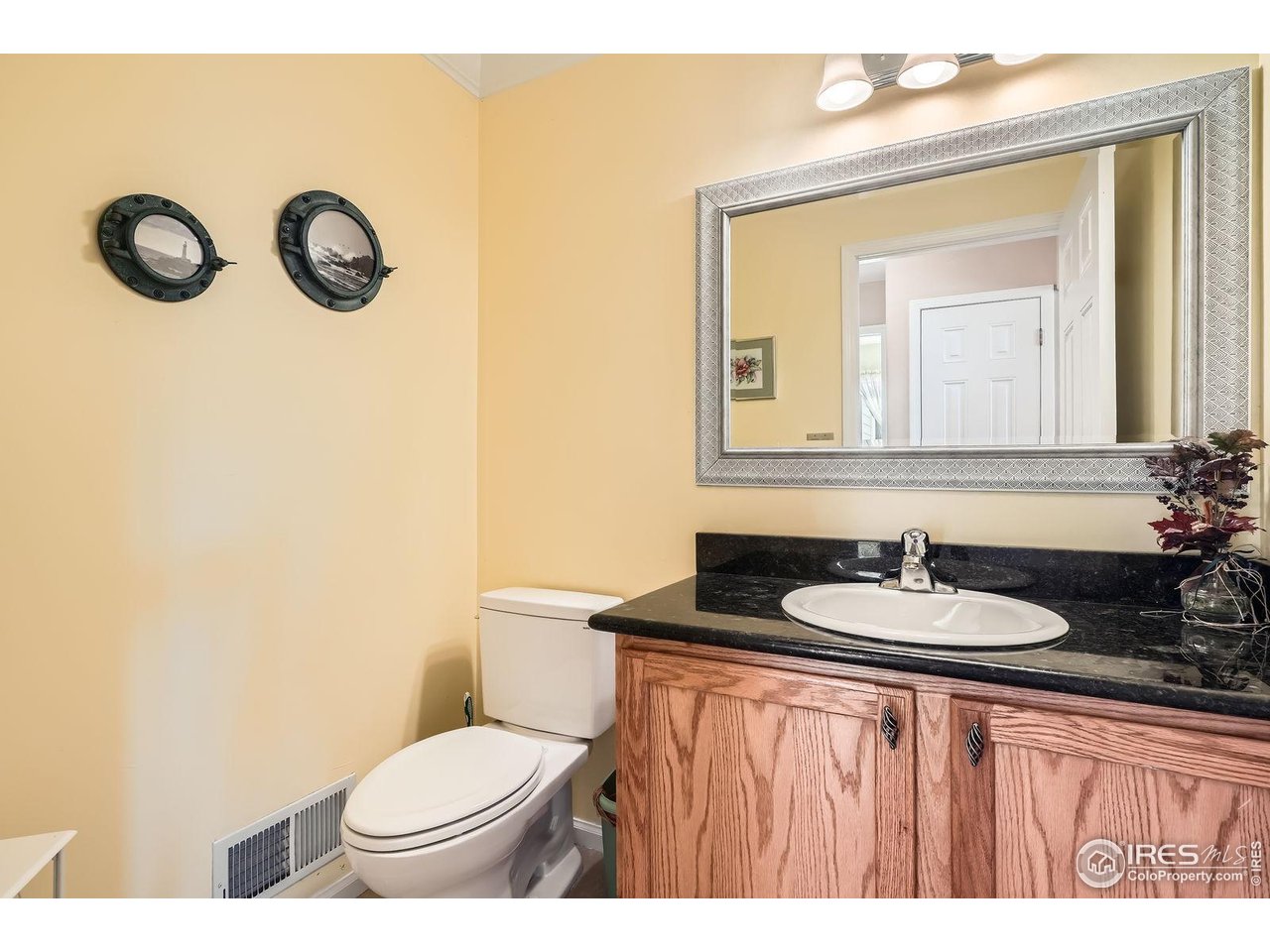 557 Highpoint Circle Black Hawk, CO 80422 - Photo 21 of 32 a bathroom with a toilet sink and mirror
