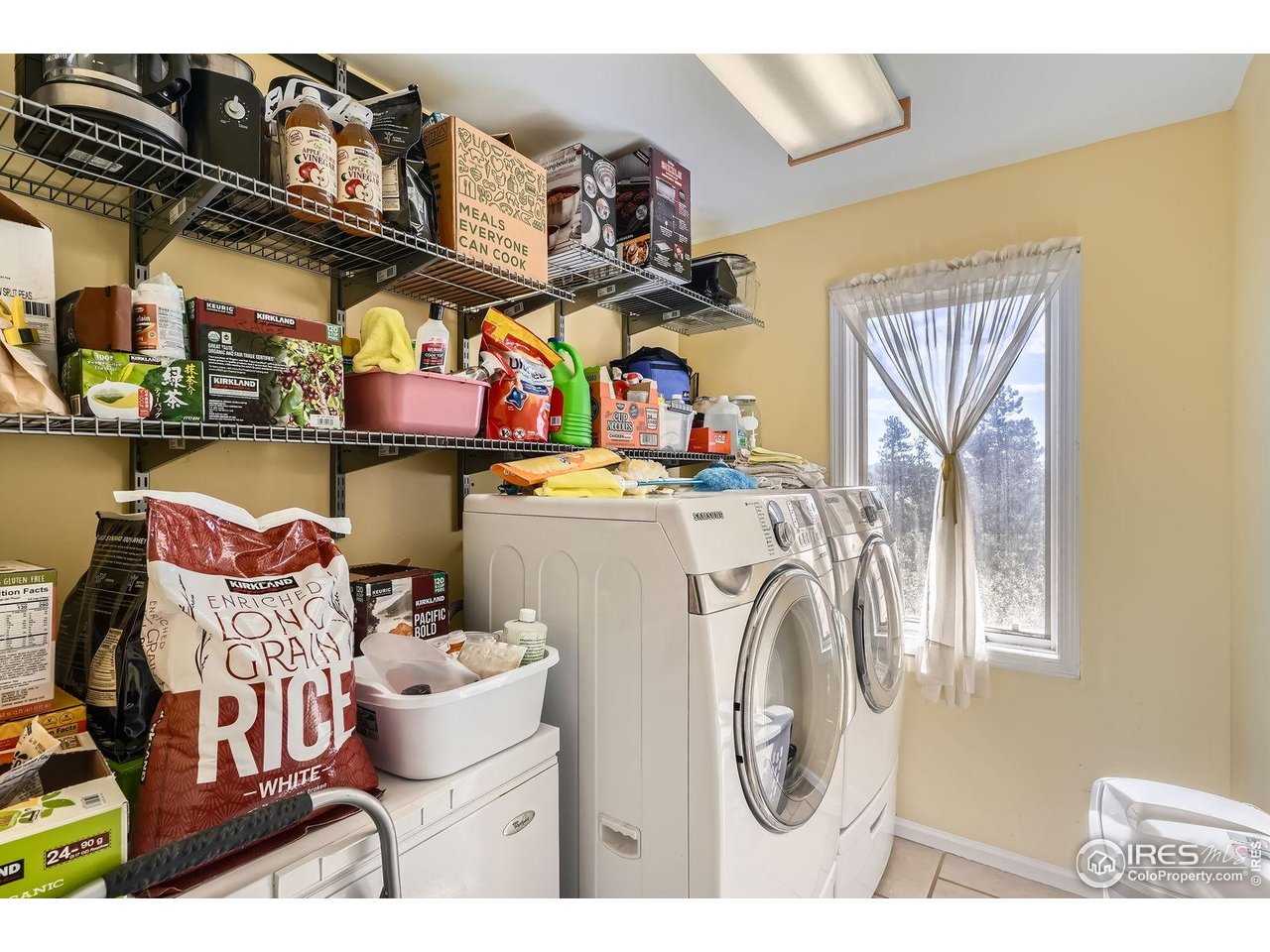 557 Highpoint Circle Black Hawk, CO 80422 - Photo 22 of 32 a utility room with dryer washer and a view of living room