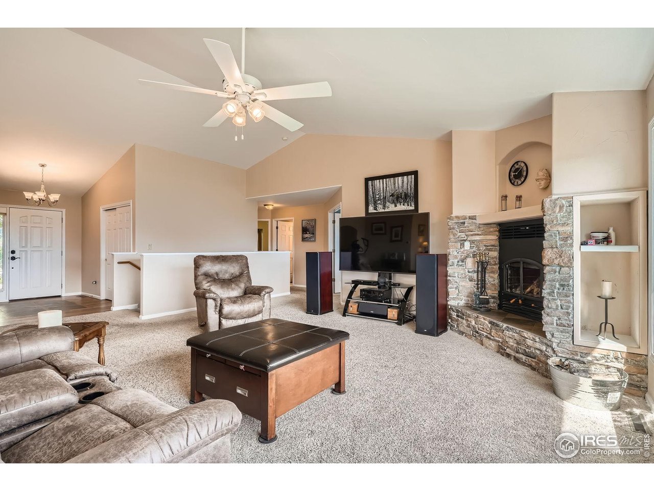 557 Highpoint Circle Black Hawk, CO 80422 - Photo 5 of 32 a living room with furniture a flat screen tv and a fireplace