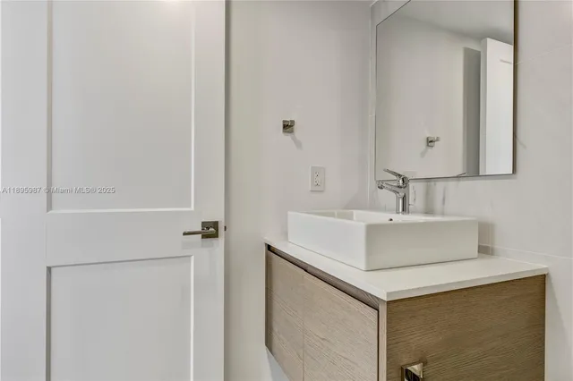 a bathroom with a sink and a mirror