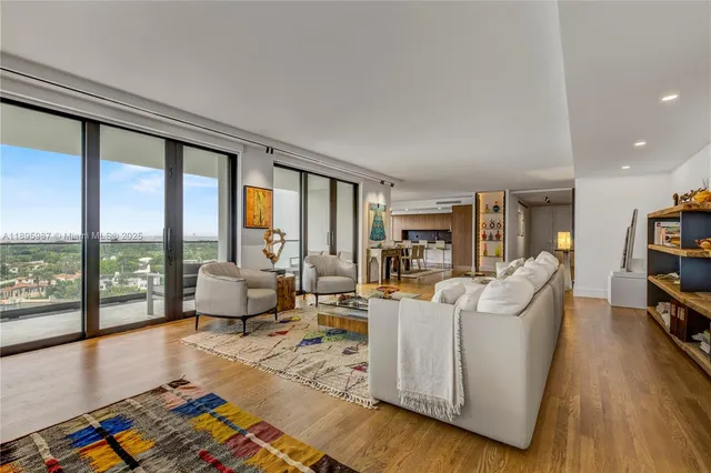 a living room with furniture and a floor to ceiling window