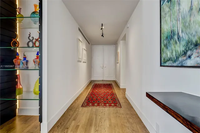 a view of hallway with wooden floor