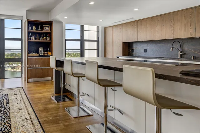 a kitchen with stainless steel appliances a stove a sink and a refrigerator