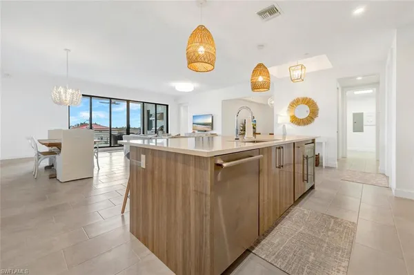 a living room with stainless steel appliances granite countertop furniture and a kitchen view