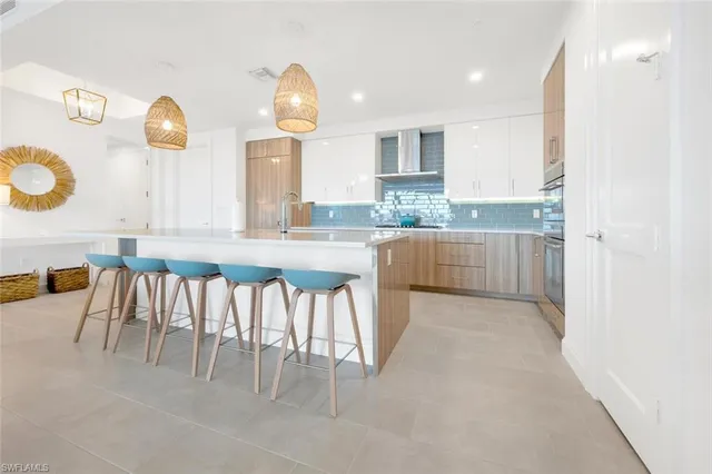 a kitchen with granite countertop a sink and white cabinets