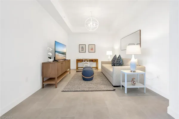 a living room with furniture and a lamp