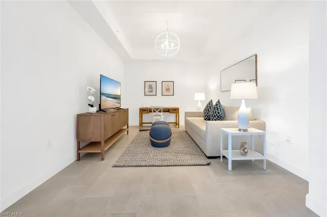 a living room with furniture and a lamp