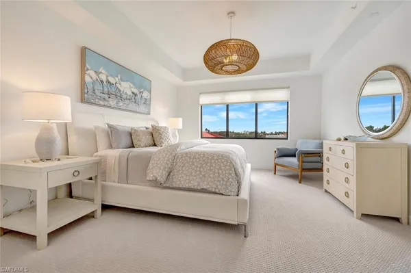 a bedroom with furniture and a large window