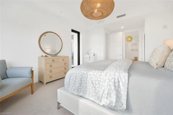 a bed room with a bed and a chandelier