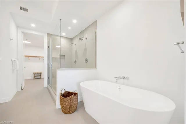 a bathroom with a bathtub and a shower