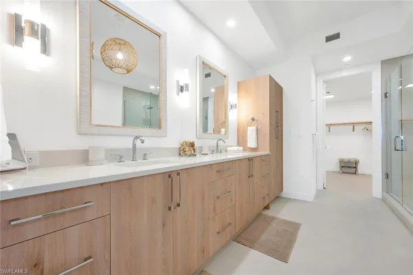 a spacious bathroom with a double vanity sink mirror and double