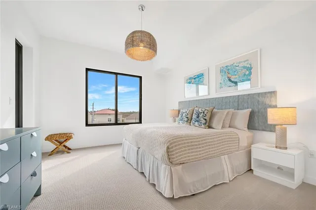 a bedroom with a bed and a painting on the wall