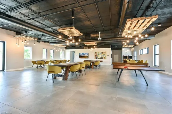a large white kitchen with kitchen island a stove a sink and a dishwasher