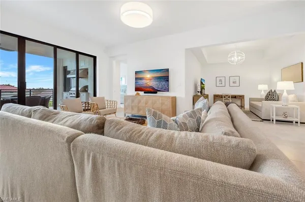 a living room with furniture and a large window