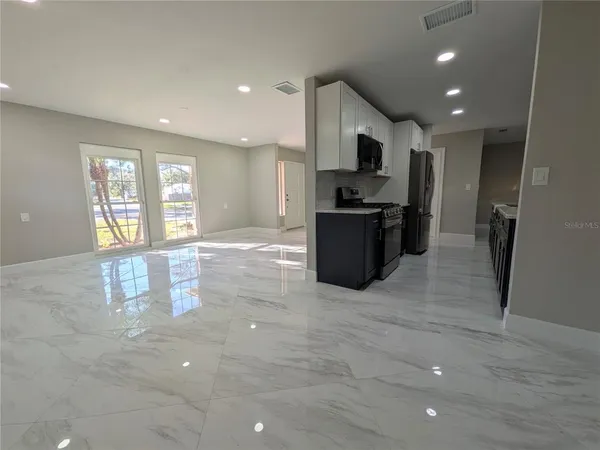 a view of kitchen with microwave and cabinets