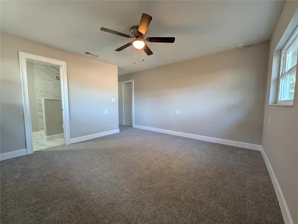 a view of an empty room with a window