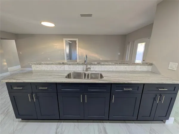 a sink with wooden cabinets