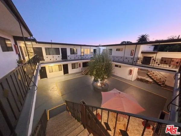 a front view of a house with outdoor seating