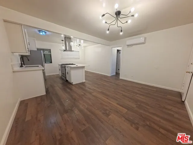 a view of a kitchen with wooden floor and a ceiling fan