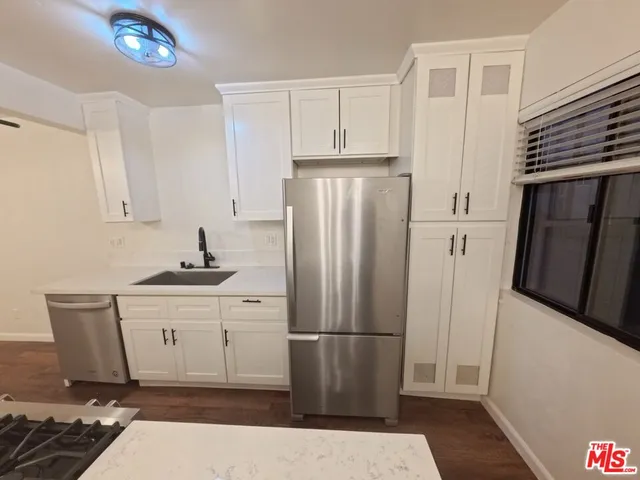 a kitchen with stainless steel appliances a refrigerator and a stove