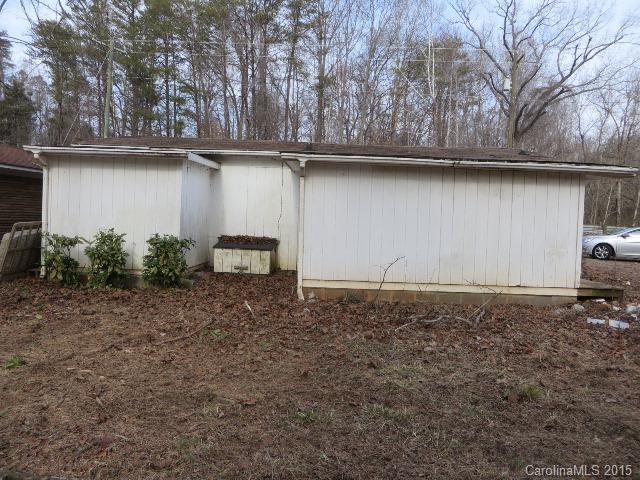 3911 Robinson Road Newton, NC 28658 - Photo 9 of 12 a backyard of a house with large trees and a wooden fence