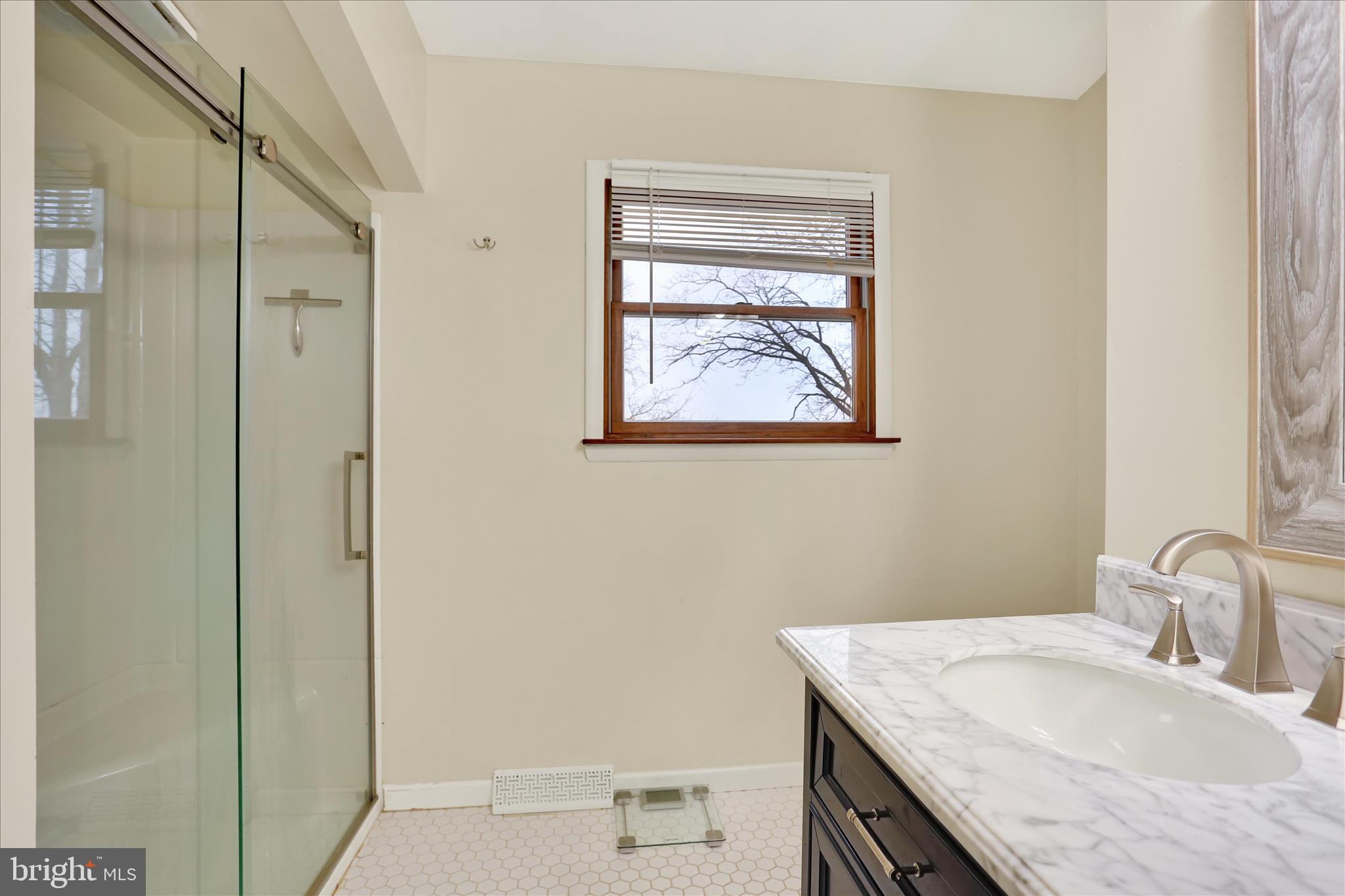 203 Pembroke Drive Shillington, PA 19607 - Photo 25 of 41 a bathroom with a granite countertop sink a mirror and a shower