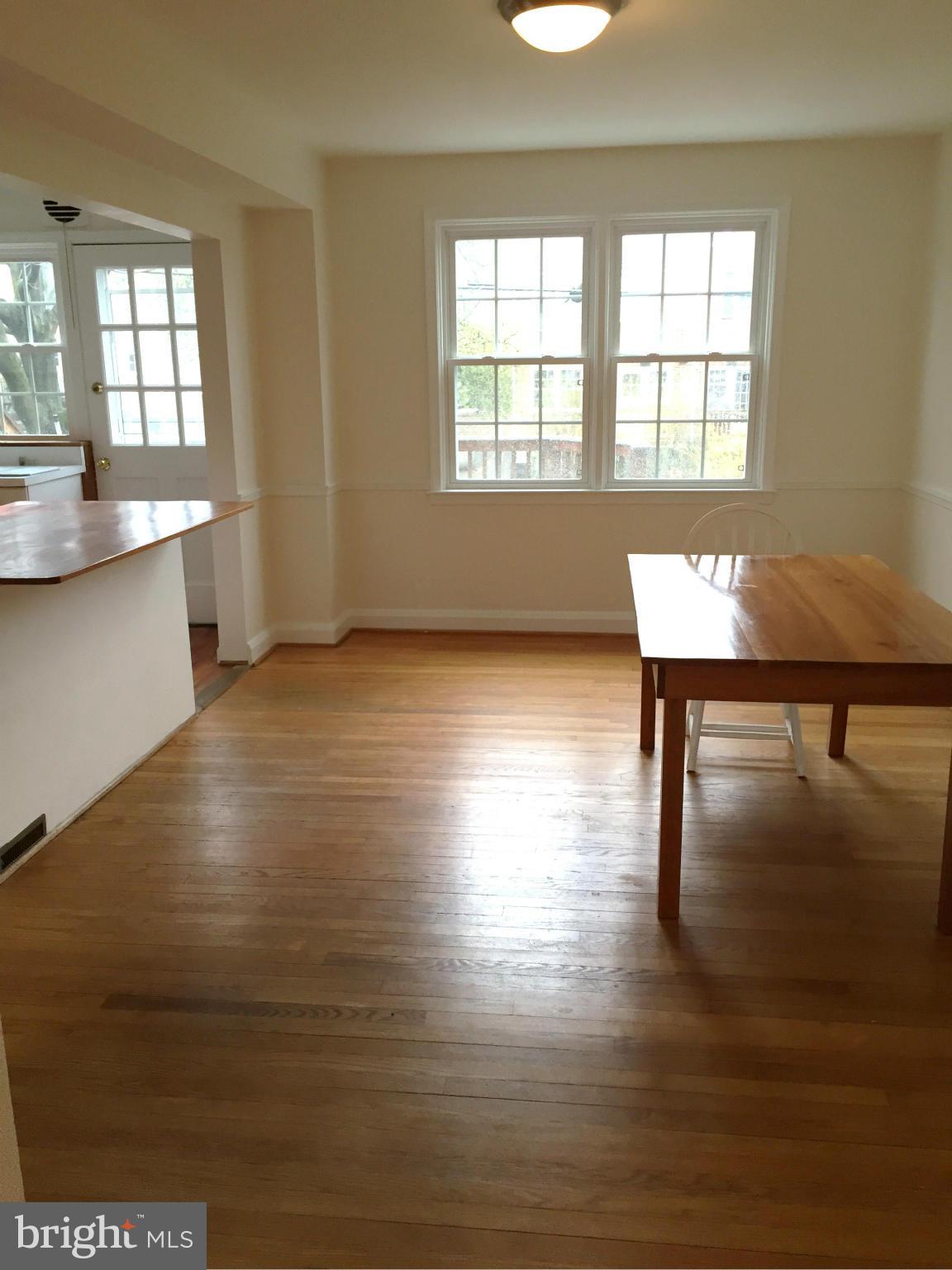 207 Stanmore Road Baltimore, MD 21212 - Photo 2 of 7 a view of a room with wooden floor and a window