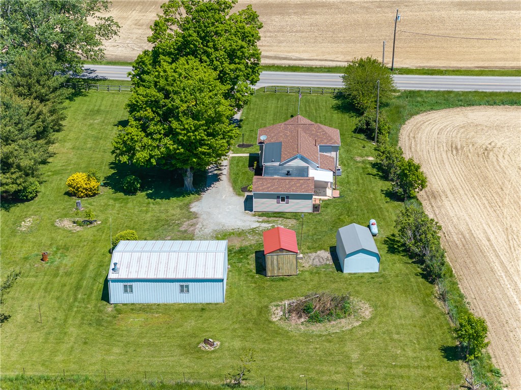 1217 Jasper Road Xenia, OH 45385 - Photo 14 of 62 An aerial perspective reveals a charming home amidst vast green spaces and agricultural fields.