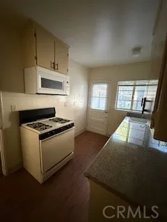 a kitchen with stainless steel appliances granite countertop a stove and a refrigerator