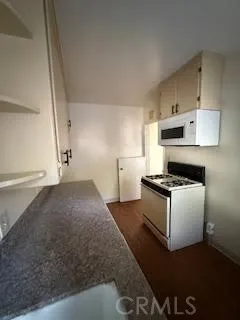 a kitchen with granite countertop a stove and a sink