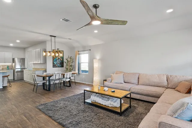 a living room with furniture and wooden floor