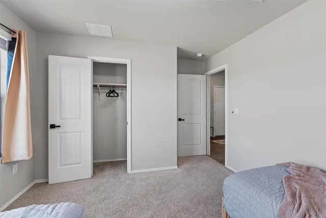 a bedroom with two beds and a window