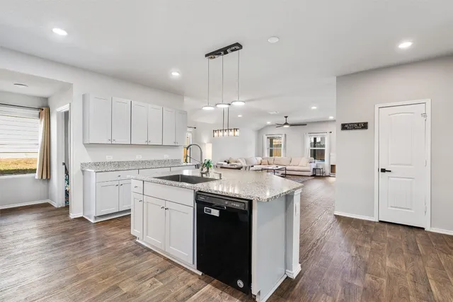 a kitchen with a sink window and cabinets