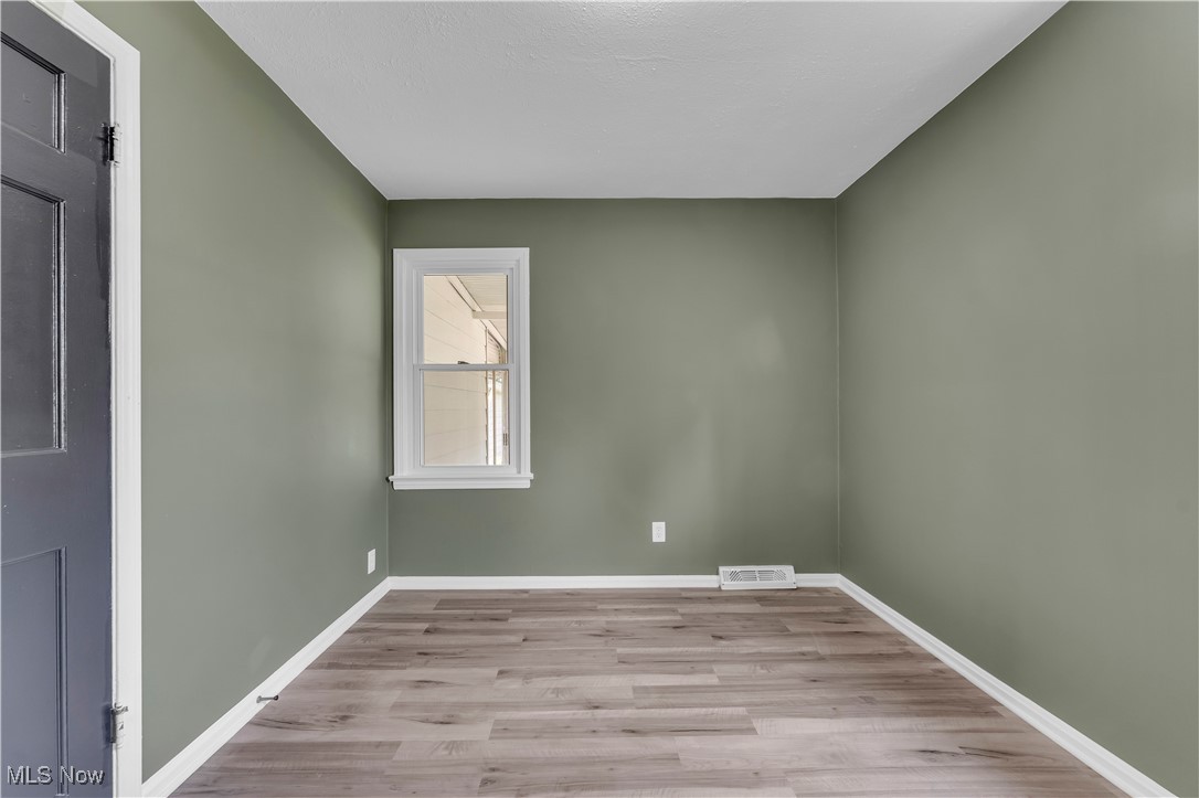 20813 Hansen Road Maple Heights, OH 44137 - Photo 19 of 40 Unfurnished room with wood finished floors and baseboards