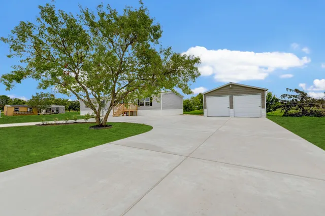 a front view of house with yard and green space