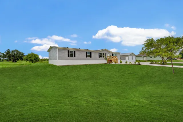 a view of a house with a backyard